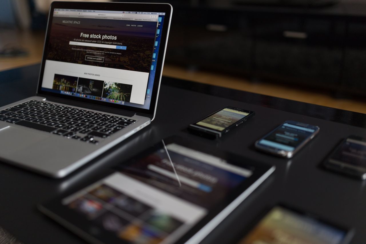 A modern work setup featuring a laptop, tablet, and smartphones, perfect for tech projects and freelance work.